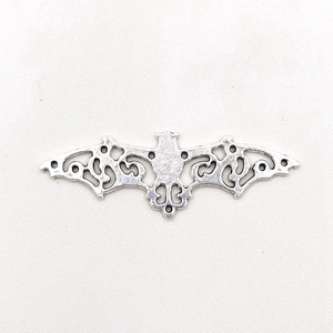 Detailed view of a 56mm silver bat pendant with intricate hollow patterns and link rings