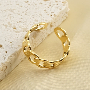 Detail of an 18k gold-plated stainless steel chain-style open ring on silk fabric