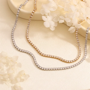 Detail of gold and silver tennis necklaces with sparkling round cubic zirconia stones
