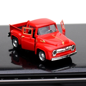 Close-up of a red vintage alloy pickup truck model with opening doors and chrome details