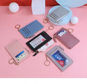 Multiple colors of faux leather card holders with gold zippers and transparent ID windows