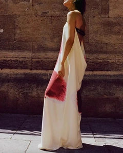 Detail of red abstract print on white backless maxi dress with black buckle strap