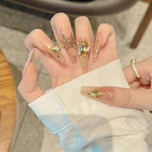 Handmade coffin nails with nude gradient, butterfly pattern, and champagne gemstones