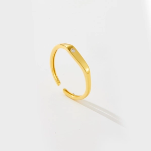 Adjustable S925 sterling silver ring in gold finish with a small clear gemstone inlay