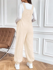 Rear view of cream corduroy maternity overalls featuring adjustable straps and tapered cuffs
