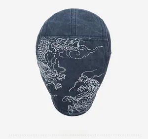 Top view of vintage denim newsboy cap with white dragon embroidery and patchwork design