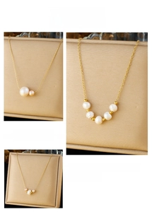 Detailed view of elegant gold chain necklaces with mixed size white freshwater pearls