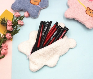 Star-shaped plush pencil case detail with zip closure and fluffy lamb wool texture