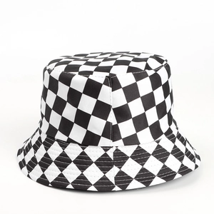 Close-up of black and white checkered bucket hat showing thick canvas texture and stitching