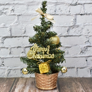 Mini desktop Christmas tree with gold ornaments and a rose gold textured base
