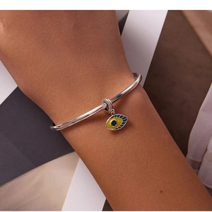 Detailed close-up of S925 sterling silver evil eye charm bracelet with blue enamel inlay
