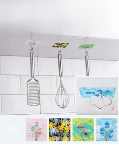 Close-up of 180 degree rotating self-adhesive wall hooks with colorful floral patterns
