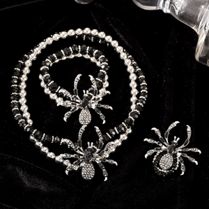 Detailed macro shot of gothic spider necklace and brooch with black beads and rhinestones