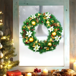 Christmas wreath with gold ornaments and white poinsettia on a white window frame