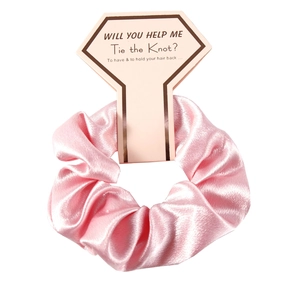 Elegant pink satin scrunchie with diamond-shaped card for wedding party favors