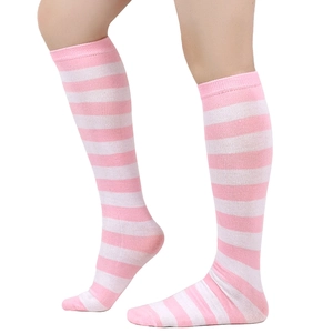 Detail shot of pink and white striped knee high socks made from soft knitted cotton fabric