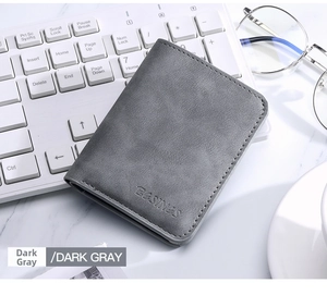 Slim dark gray card holder wallet on mechanical keyboard with glasses in modern scene
