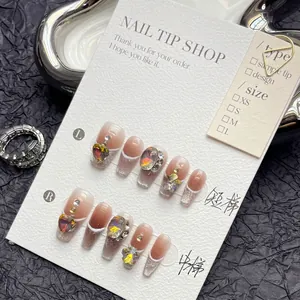 Luxury bow press-on nails with amber cat-eye gradient and rhinestones in medium coffin shape