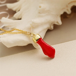 Colorful lucky hand pendant necklace with gold chain on a white shell background