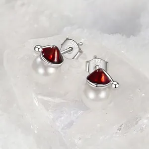 Minimalist S925 sterling silver Christmas hat pearl stud earrings on snow background