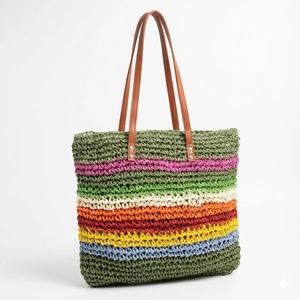 Handwoven rainbow striped straw tote bag with brown leather straps for beach vacation