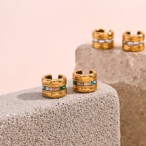 18K gold plated ear cuff featuring emerald and champagne square-cut zircons on stone background
