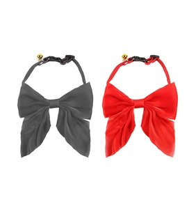 Detail of red and black pet bow tie collars with adjustable buckles and gold bells