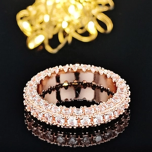 Macro shot of rose gold eternity ring with three sides of micro-paved cubic zirconia