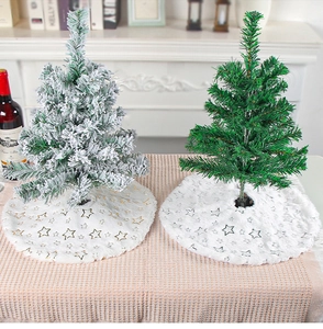 Detail view of plush white Christmas tree skirts with gold and silver star embroidery