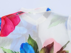 Detailed view of women floral chiffon blouse featuring round neck and ruffle trim details
