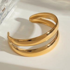 Polished double-layered gold stainless steel open bangle with a minimalist reflective finish