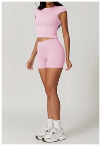 Pink yoga set featuring a crewneck crop top and high-waisted shorts with high-stretch fabric