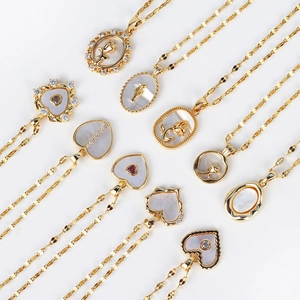 French vintage stainless steel shell necklace with gold heart and flower pendants