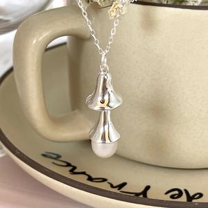 925 silver necklace with unique double bell pendant and pearl on ceramic cup edge