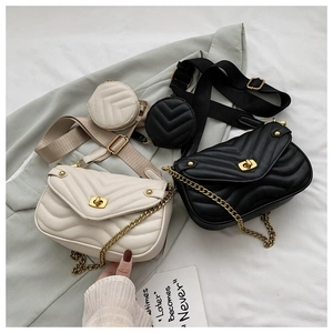 Detailed close-up of V-quilted texture with golden chain strap and mini round pouch charm