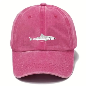 Close-up of pink washed cotton baseball cap with detailed shark embroidery on the front