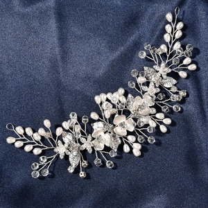 Detail of silver alloy bridal hair vine with crystal flowers and white teardrop pearls