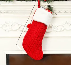 Detail view of red knitted Christmas stocking with dimensions 18cm, 40cm, and 22cm