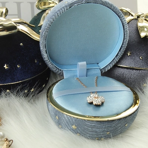 Velvet round jewelry boxes with gold star patterns and bow decoration in three colors
