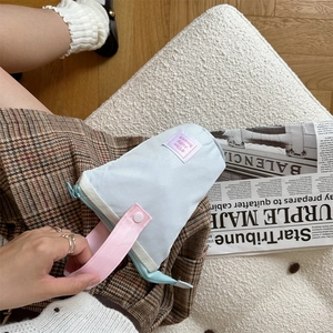 Detail of blue stationery pouch with pink handle and The Jolly house label detail