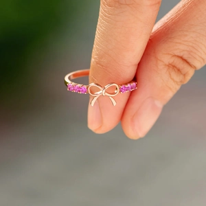 Elegant rose gold S925 silver ring featuring a pink zircon bow design on finger