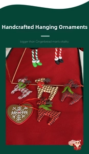 Detail of handcrafted reindeer and heart cloth ornaments with red festive hanging strings
