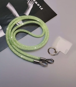 Macro detail of sparkly mesh rhinestone phone lanyard with silver metal clasps and connectors
