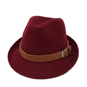 Detail of burgundy wool fedora hat featuring a brown faux leather belt and silver buckle