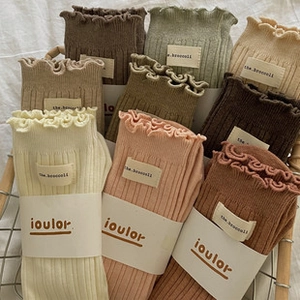 Close-up of ruffled cuff socks with ribbed texture in various warm autumn colors
