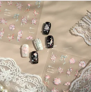 Close-up of M-941 nail art stickers with pink butterfly, floral patterns and glitter detail