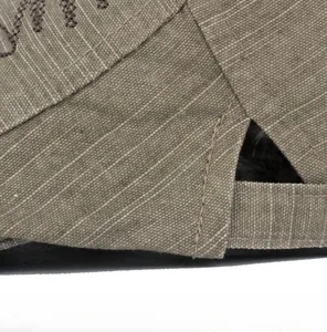 Macro shot of fine stitching and twill fabric texture on a vintage brown newsboy hat