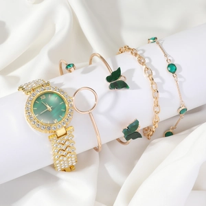 Detailed view of emerald green watch set with butterfly bracelets on white silk display