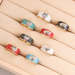 Detailed row of gold evil eye heart rings with colorful enamel inlay and sparkling cubic zirconia