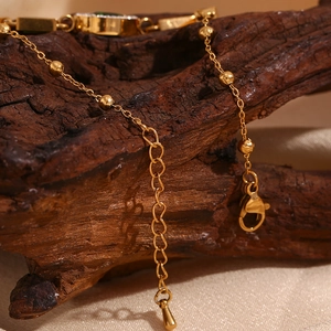Detail of 18K gold plated bracelet chain with lobster clasp and adjustable droplet charm